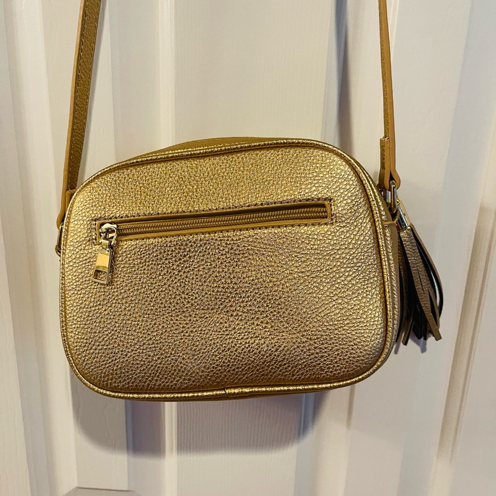 Beautiful GOLD not muted gold. I was given this bag, but have not used it yet.